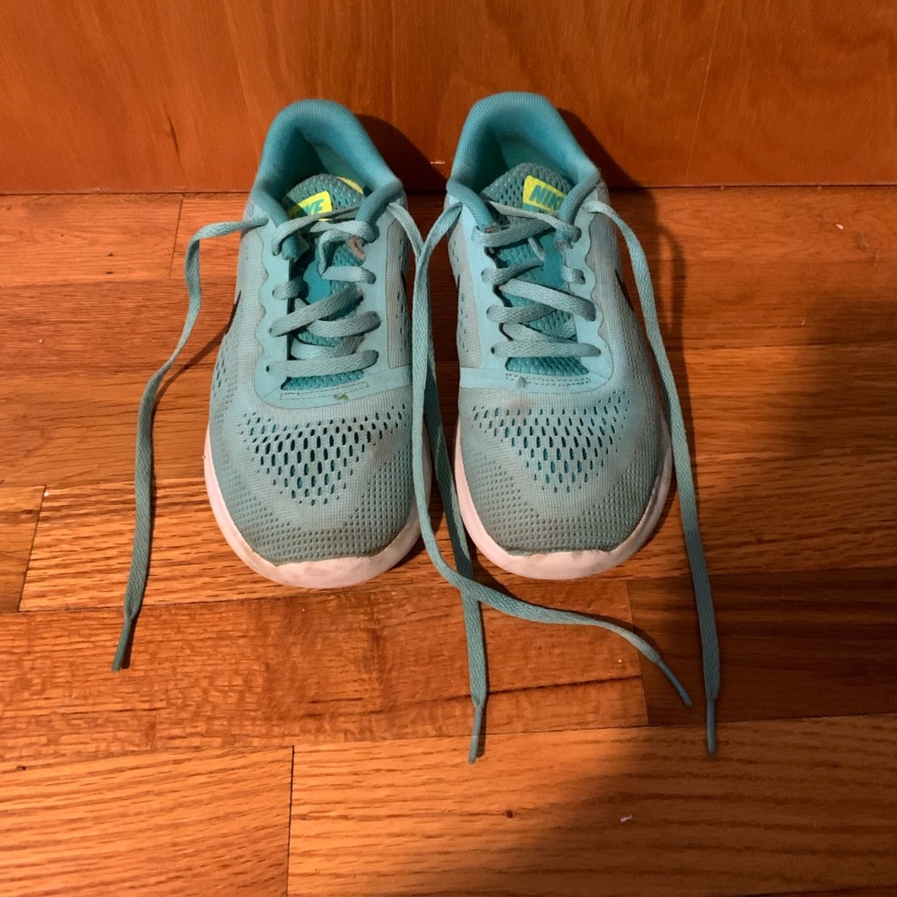 Teal child’s Nike sneakers